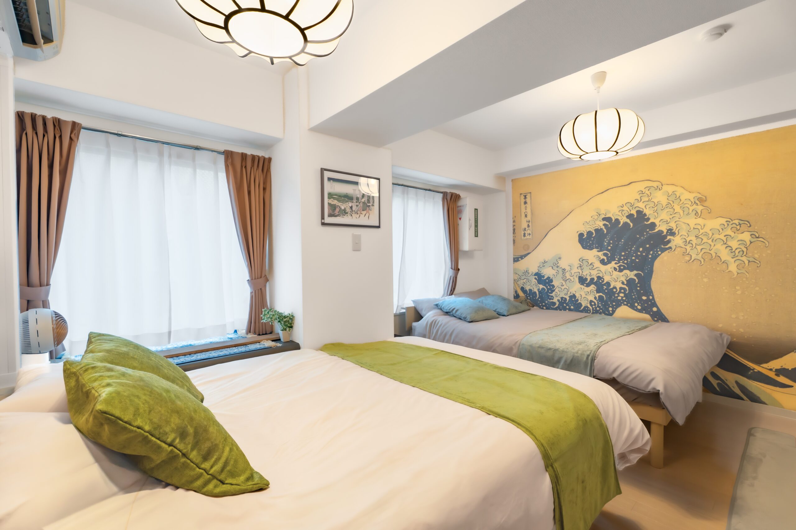 Sugamo Yasu Hotel — Hokusai wave mural room with two beds and lantern light